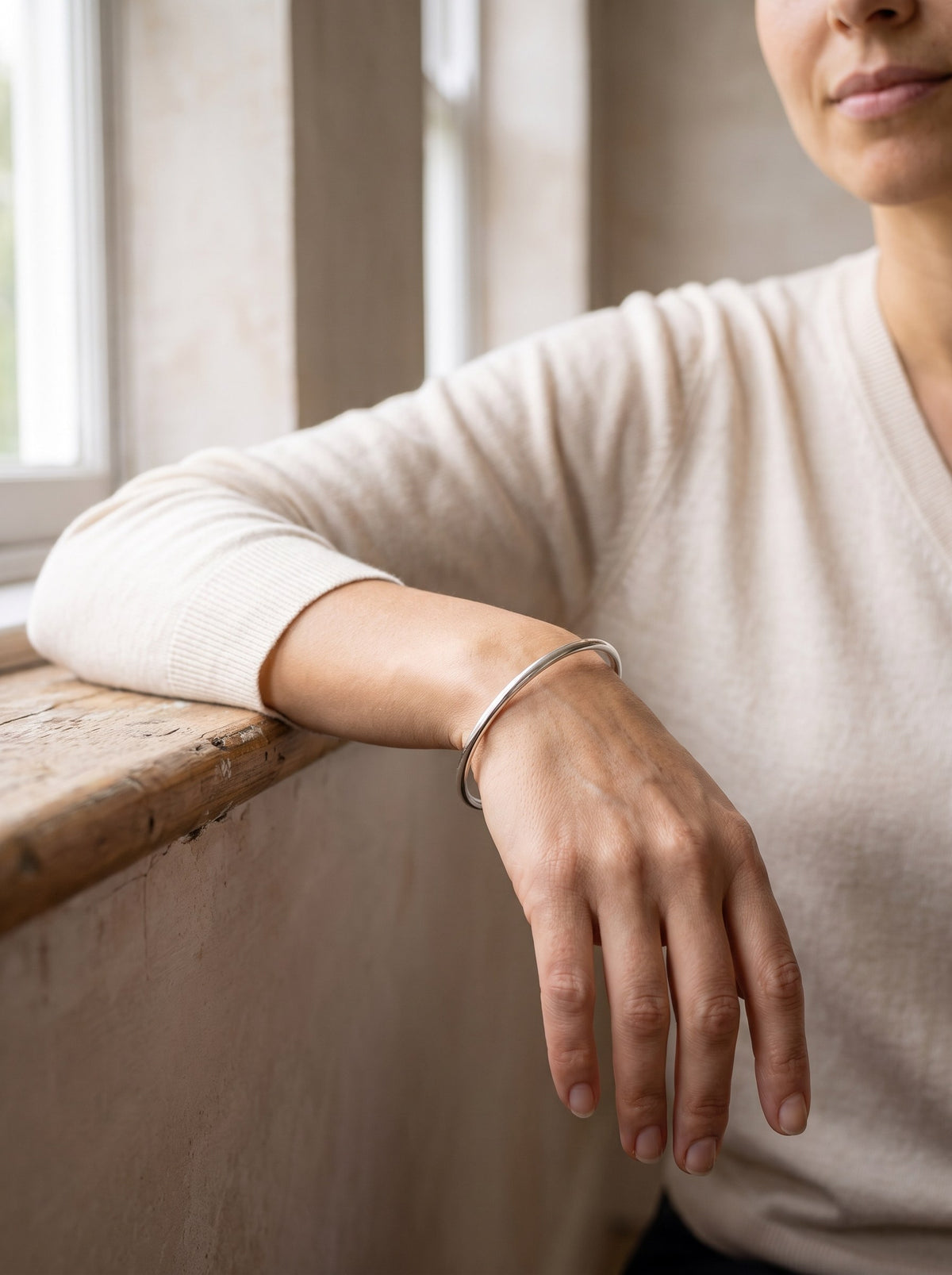 Woman wearing the Fine Open Cuff Bangle in silver on her wrist