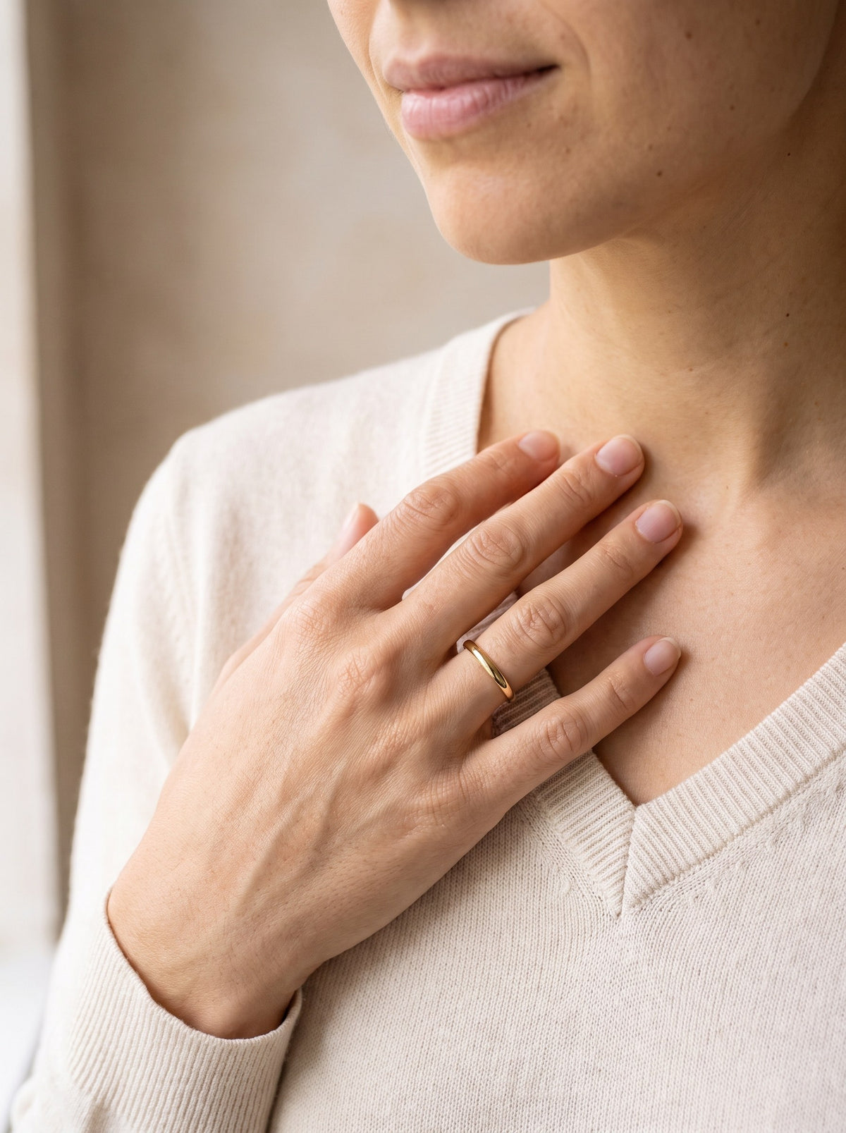 Woman wearing the Fine Stacking Ring in gold vermeil on her ring finger
