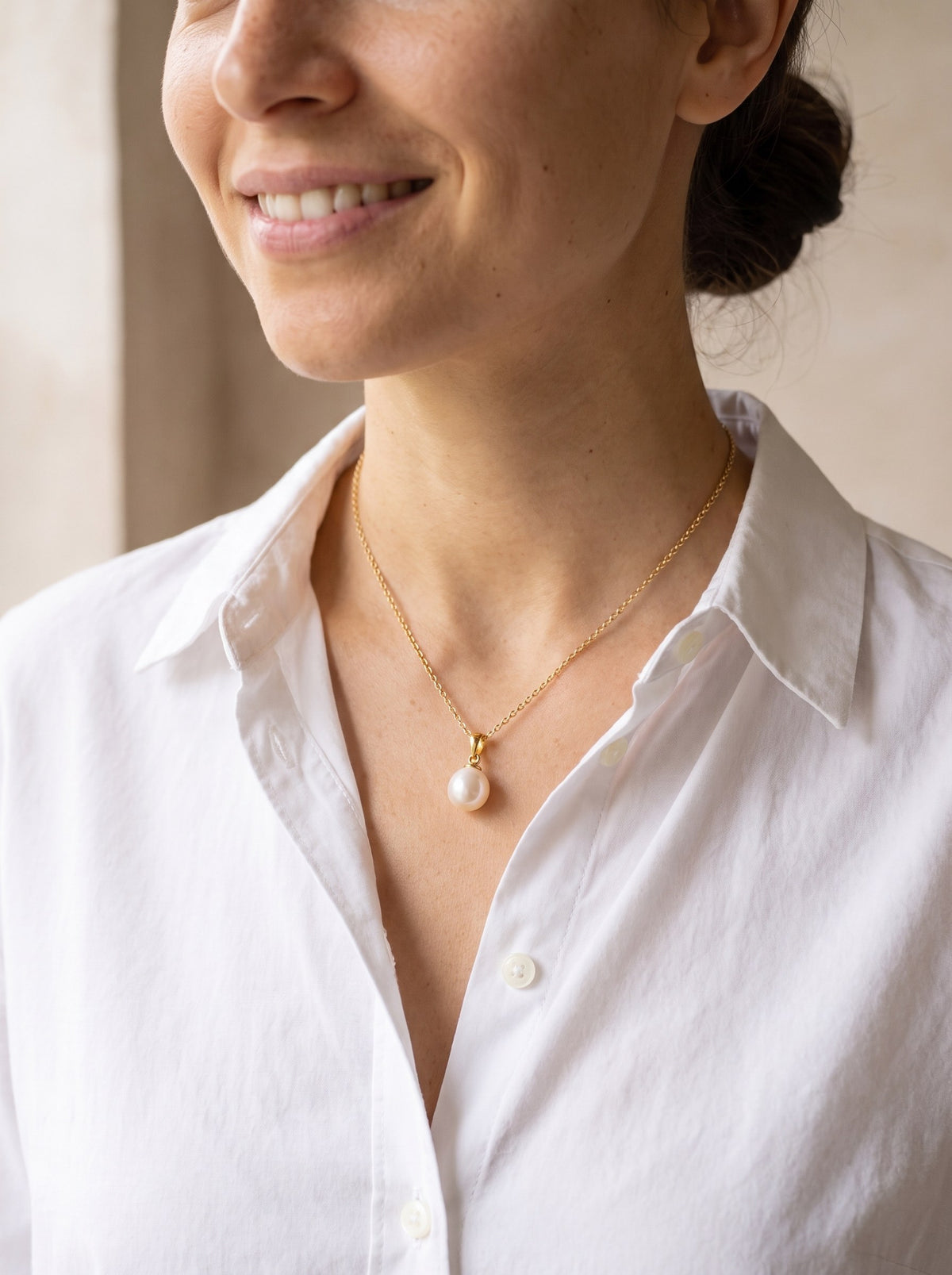 Woman wearing the Freshwater Pearl Pendant Necklace at the base of her neck