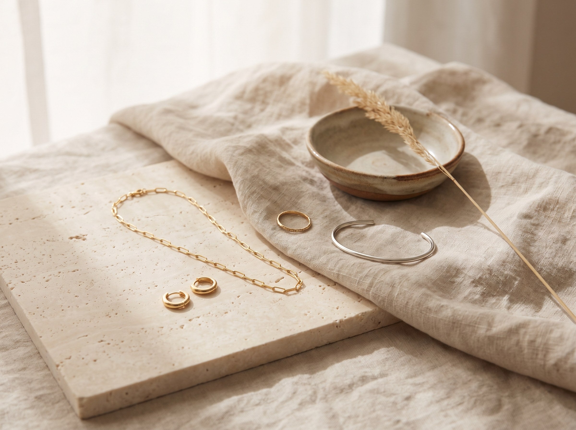 Orevane gold vermeil and silver jewellery on travertine and linen