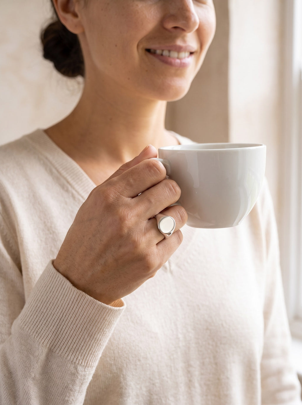 Woman wearing the Oval Signet Ring in sterling silver on her little finger