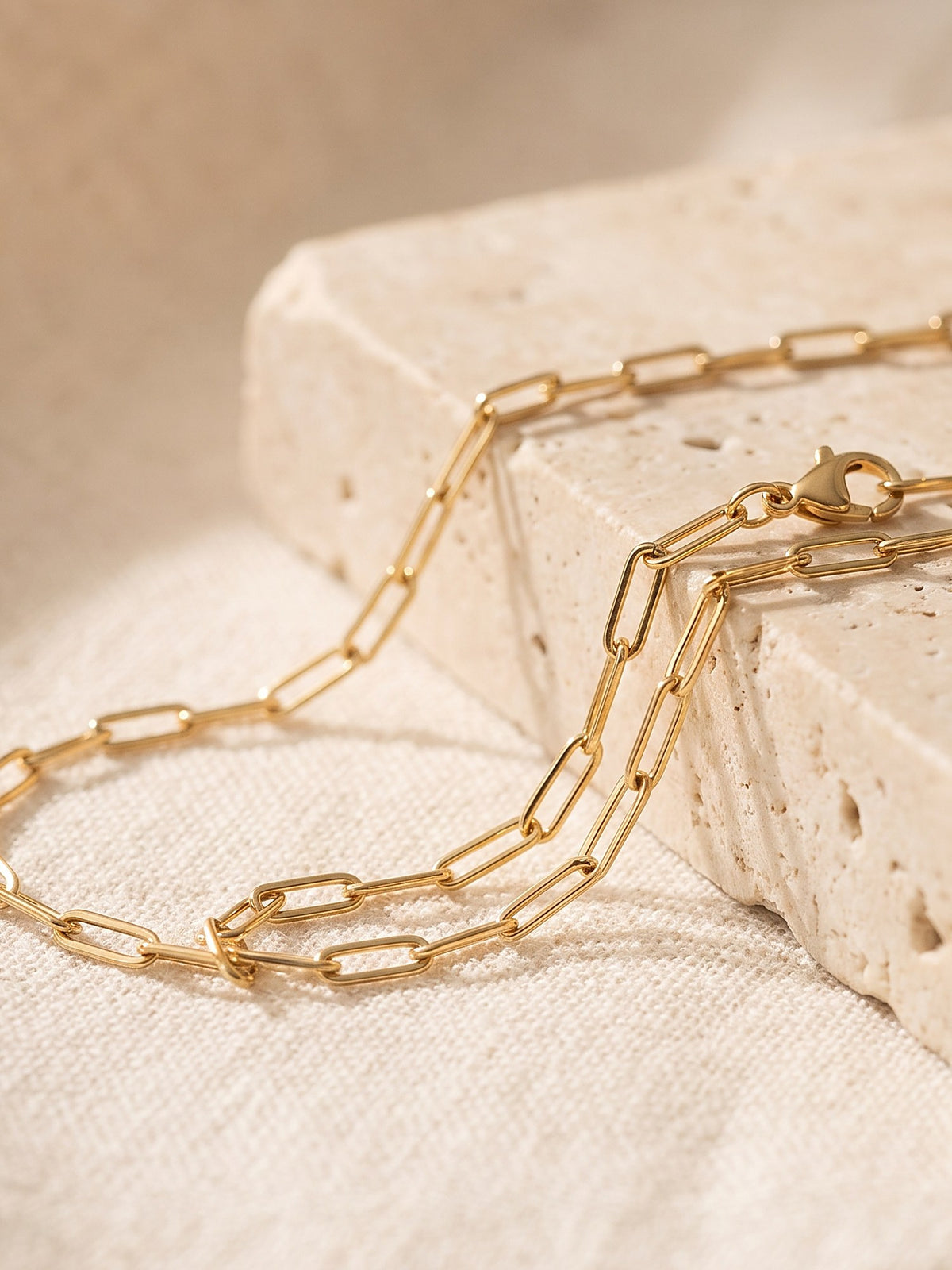 Close-up of the elongated links and lobster clasp of the Paperclip Chain Necklace