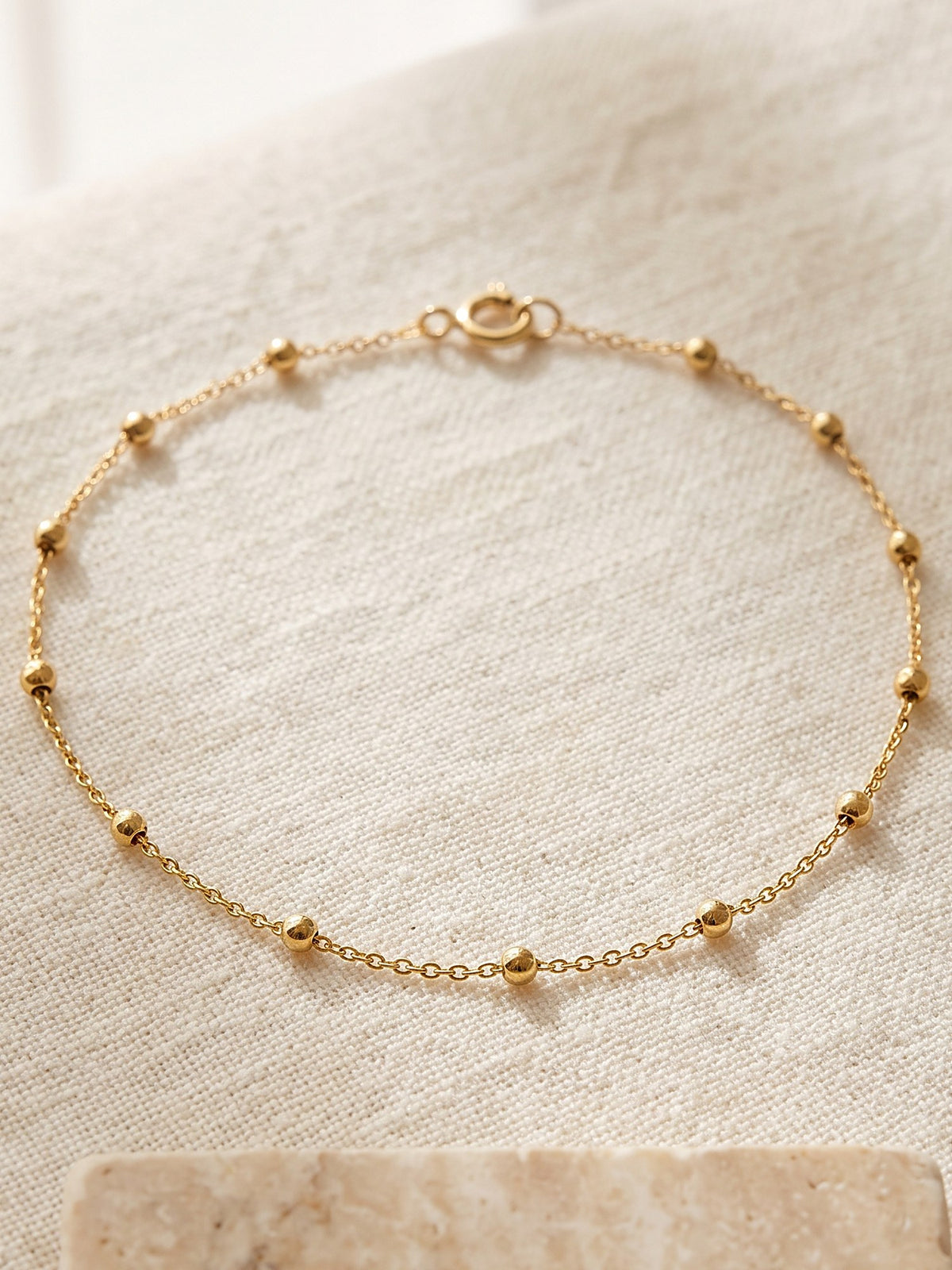 Close-up of the small polished beads on the fine Satellite Chain Bracelet